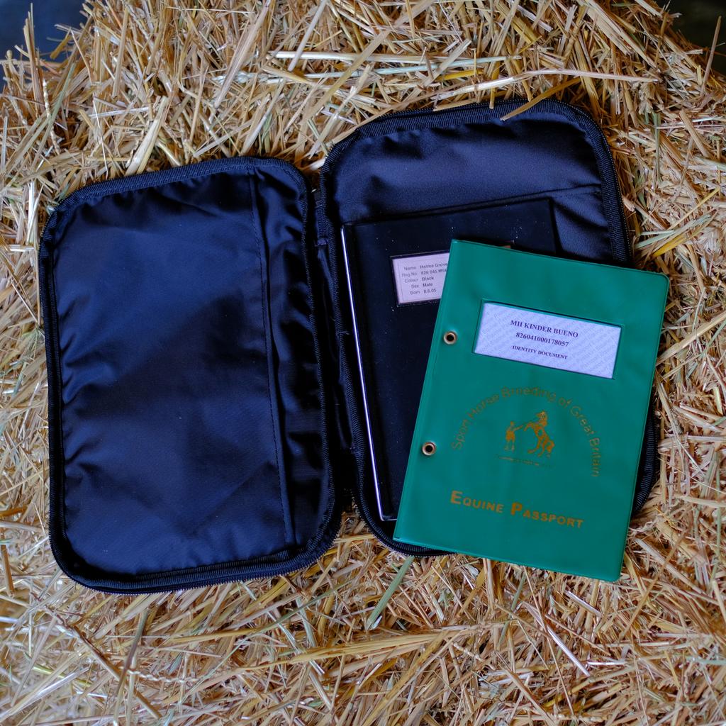 The inside of a DRYVIS customised faux leather horse passport wallet featuring two large internal pockets: one horizontal and one vertical